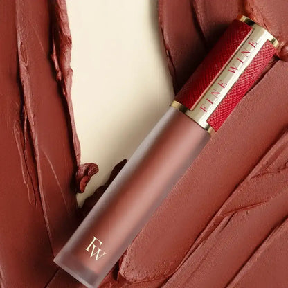 Brown-red lipstick tube with printed label and applicator tip
