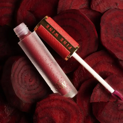 Mousse lipstick duo with red applicator and clear tube, glittery crimson shade