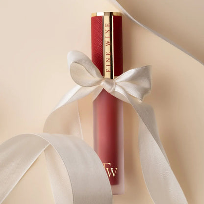 Matte SPF lip mousse lipstick with red tube tied with white bow