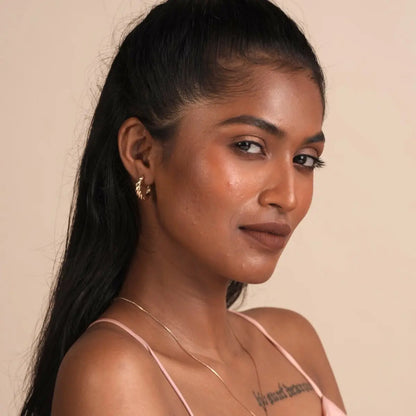 Model wearing matte SPF lip mousse lipstick, defined lips and neutral makeup close-up